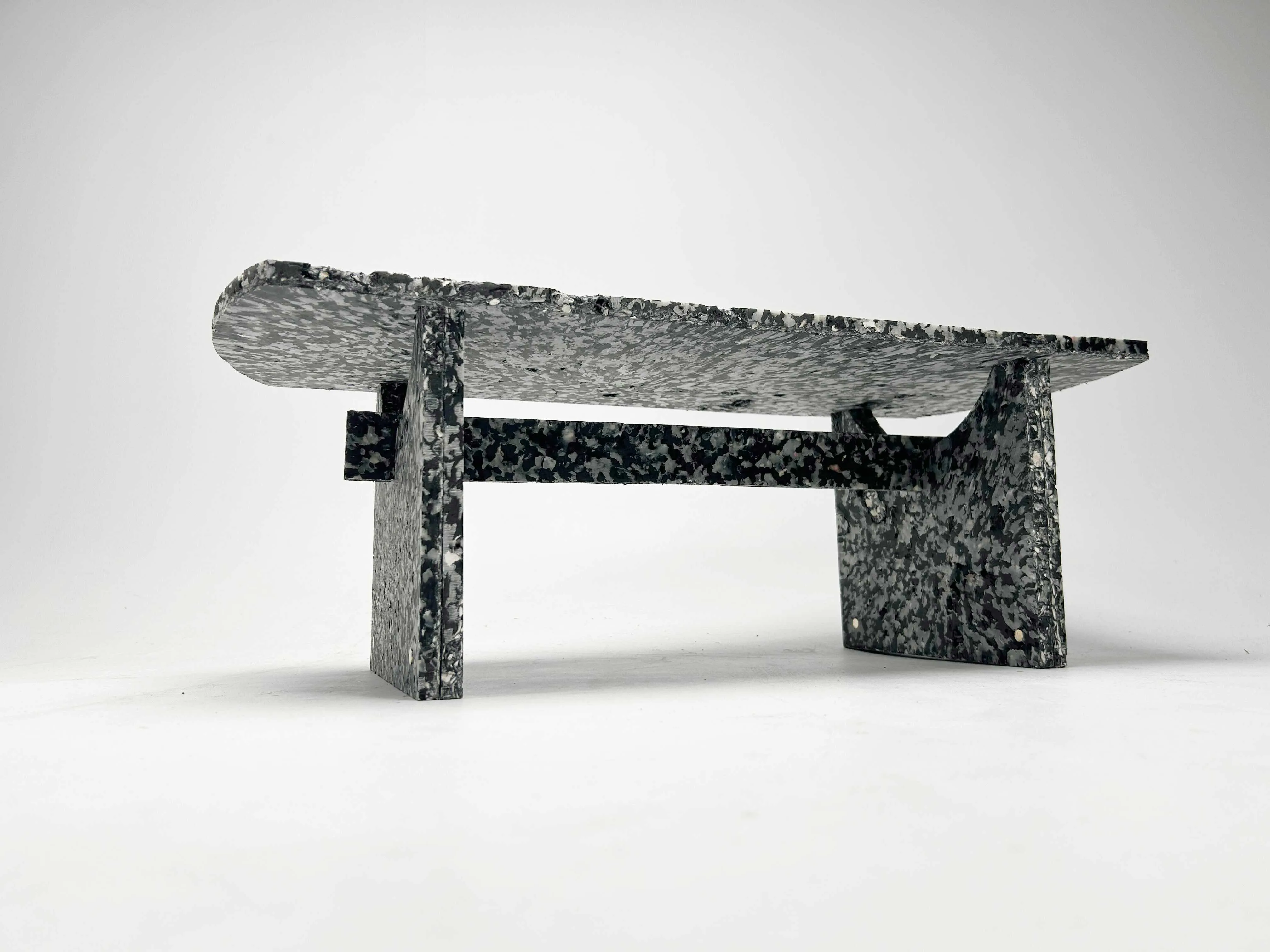 Shio, a modular bench pressed from recycled HDPE and crushed oyster shell, photographed on white seamless.