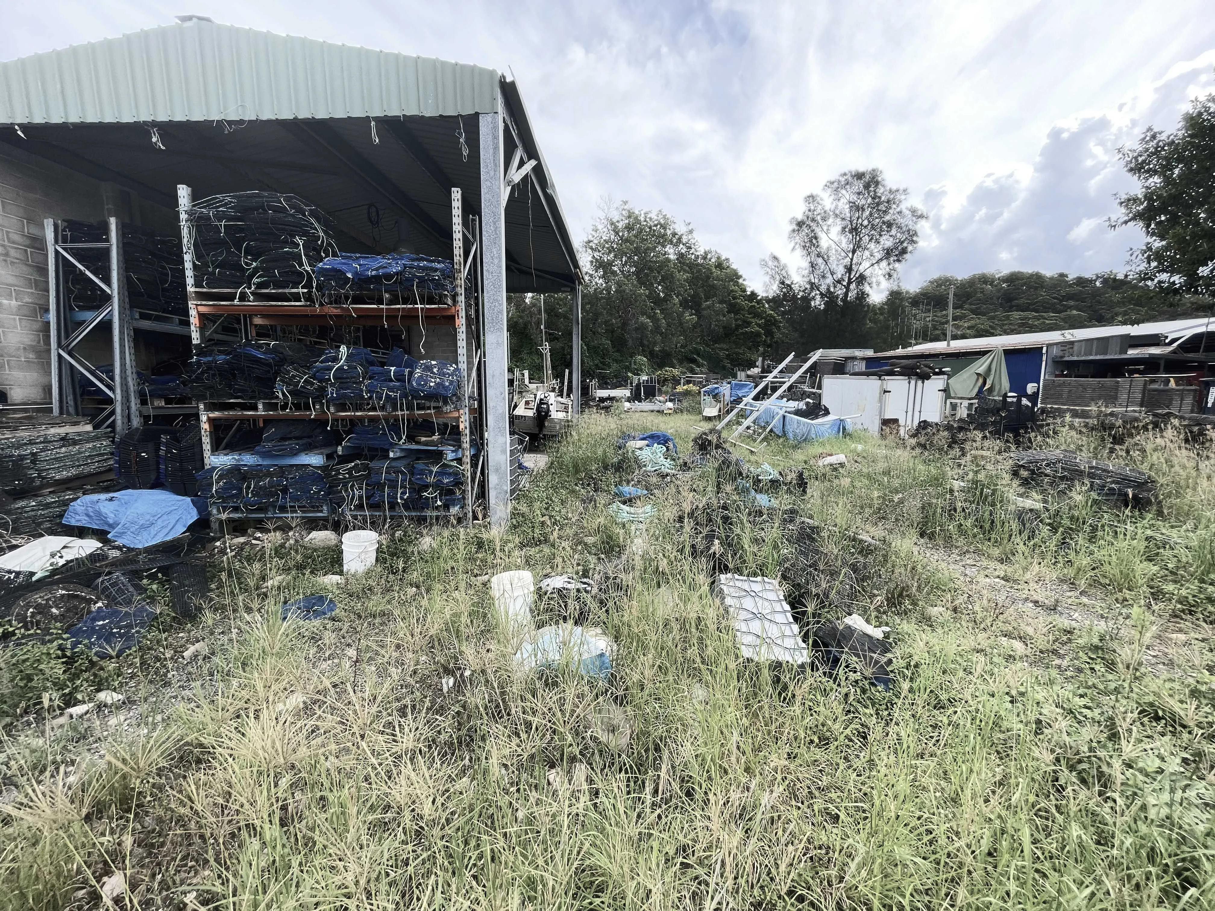 Stacked oyster racks and shell waste at Broken Bay Pearl Farm.